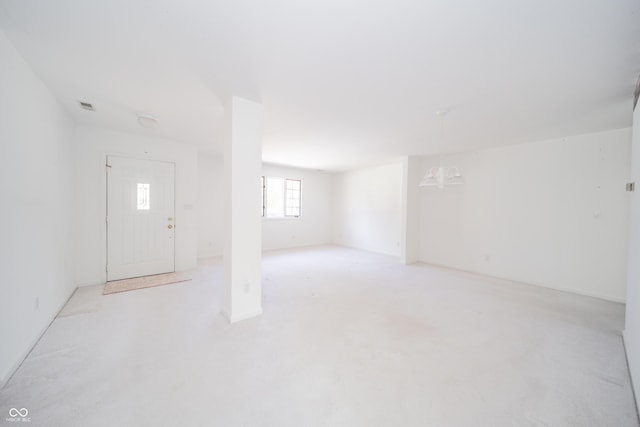 basement with a notable chandelier