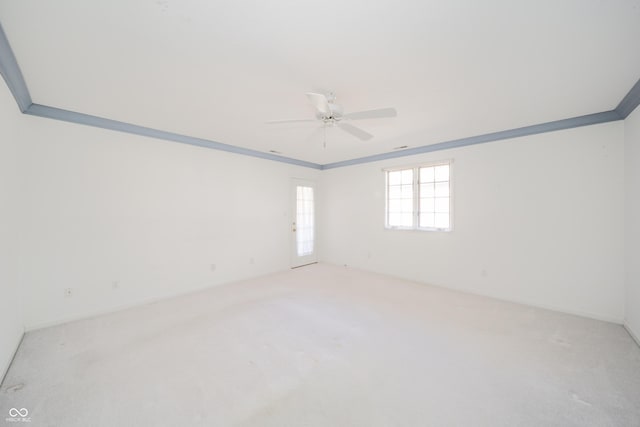 carpeted empty room with ornamental molding and ceiling fan