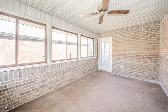 unfurnished sunroom with ceiling fan