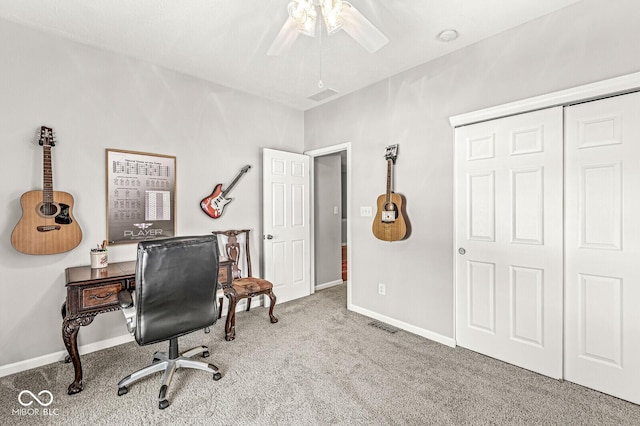 office space featuring light carpet and ceiling fan