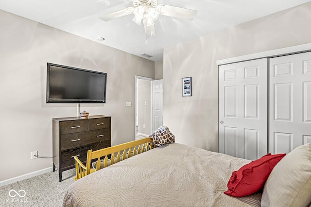 carpeted bedroom with a closet and ceiling fan