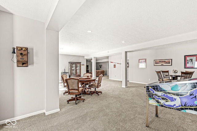 carpeted dining room with a textured ceiling