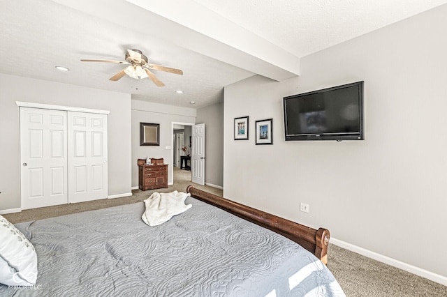 carpeted bedroom featuring a textured ceiling, a closet, and ceiling fan