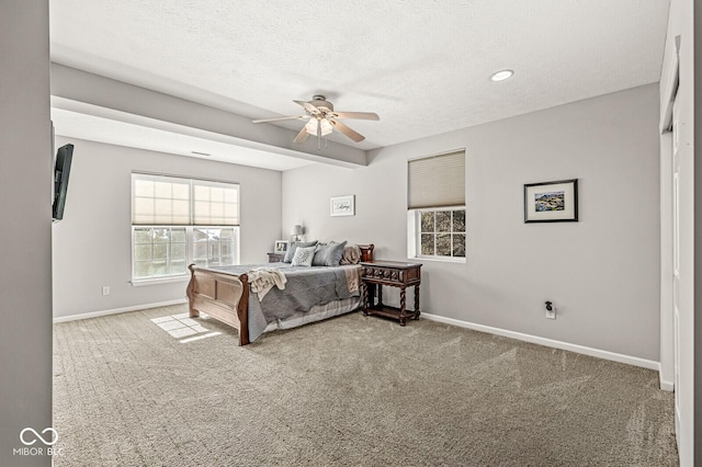 bedroom with ceiling fan, a textured ceiling, and carpet flooring