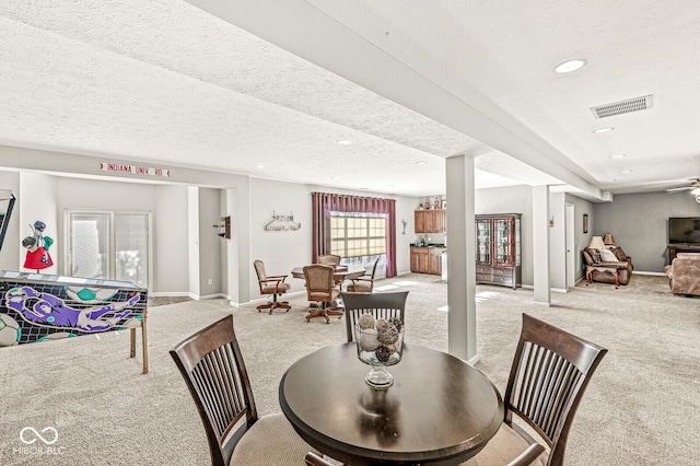 dining room with a textured ceiling and carpet flooring