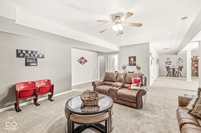 carpeted living room with ceiling fan and a textured ceiling