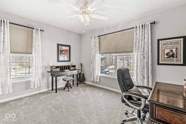 carpeted office space featuring ceiling fan