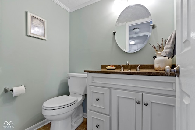 bathroom featuring vanity, ornamental molding, and toilet