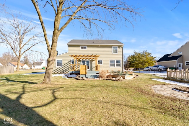 back of property with a yard and a pergola