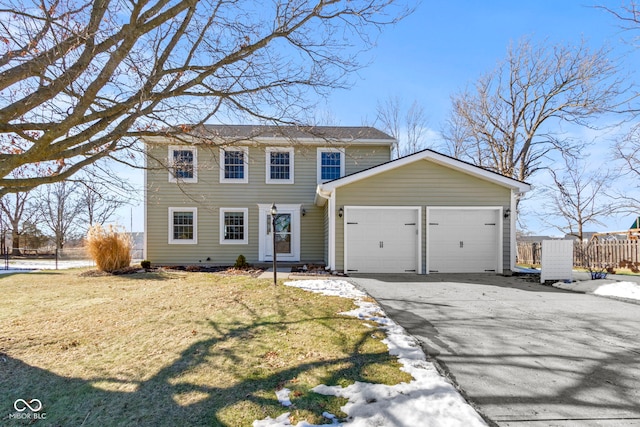 view of front of house with a garage and a front lawn