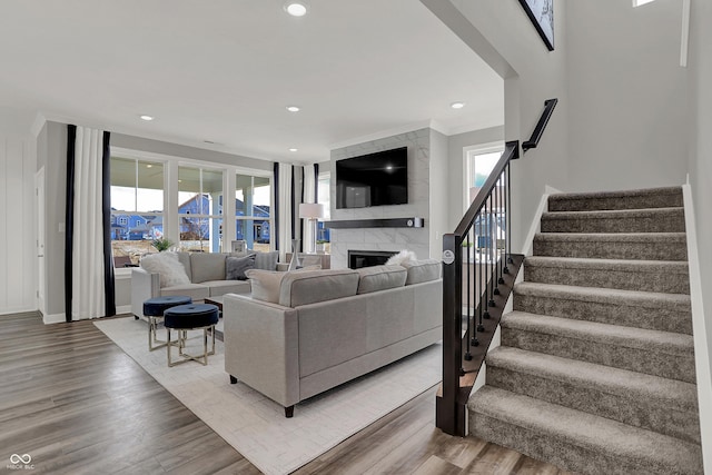 living room with a fireplace and wood-type flooring