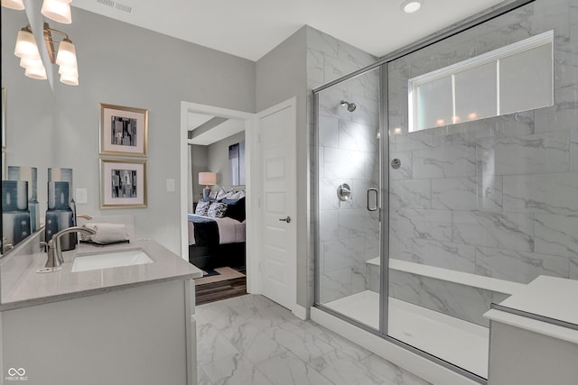 bathroom with vanity and a shower with shower door