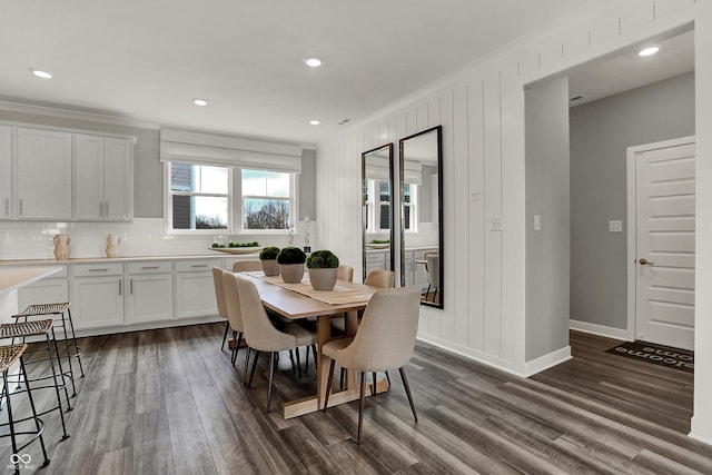 dining room with ornamental molding and dark wood-type flooring