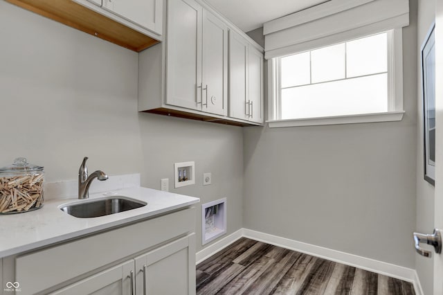 laundry room with sink, electric dryer hookup, cabinets, washer hookup, and dark hardwood / wood-style flooring