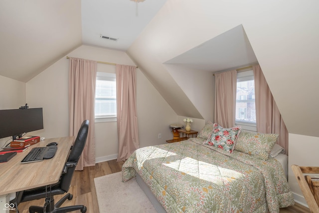 bedroom featuring vaulted ceiling and light hardwood / wood-style floors