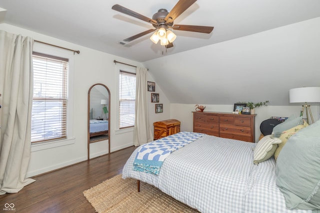 bedroom with dark hardwood / wood-style flooring, lofted ceiling, and ceiling fan