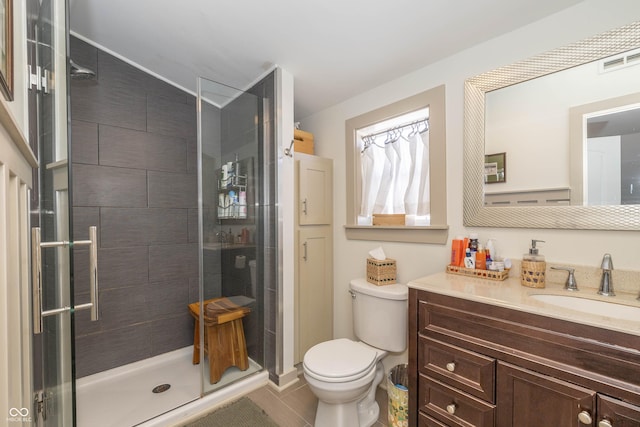 bathroom with a shower with door, vanity, and toilet