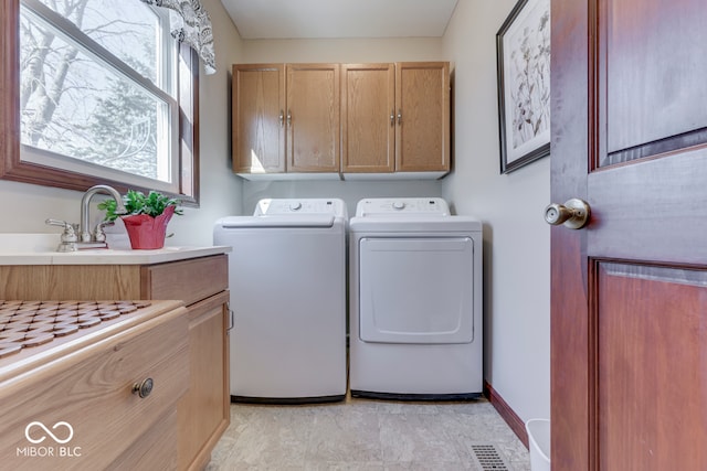 laundry room featuring cabinets and washing machine and clothes dryer