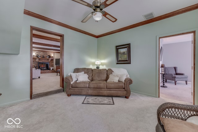 carpeted living room featuring ceiling fan, ornamental molding, and a fireplace