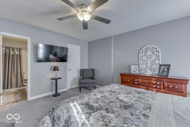 bedroom with light colored carpet, ceiling fan, and ensuite bath