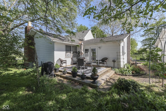 4462 S Morgantown Rd, Greenwood, IN 46143 - back of property with french doors, a chimney, fence, and a patio area