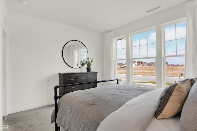 bedroom featuring light carpet