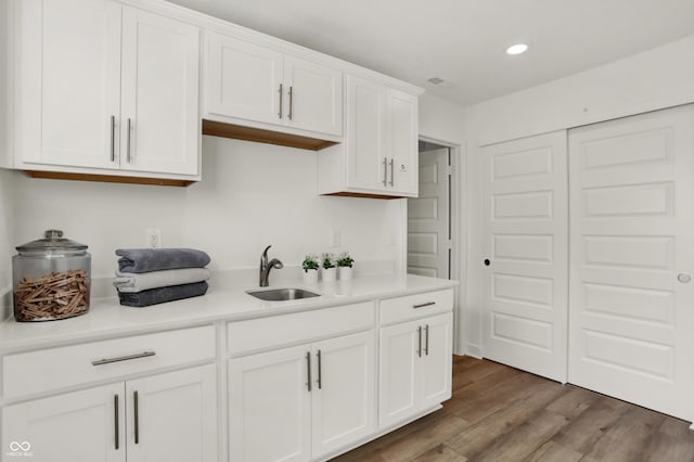 kitchen featuring sink, white cabinets, and dark hardwood / wood-style floors