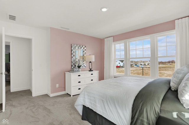 bedroom featuring light carpet