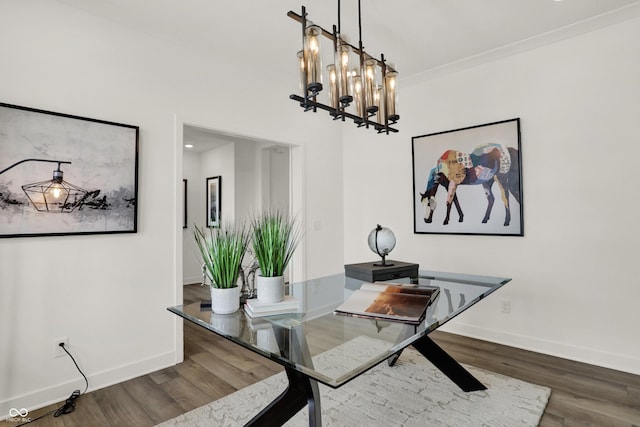 dining space with wood-type flooring and a notable chandelier