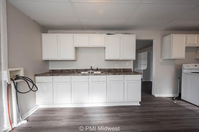 kitchen featuring a paneled ceiling, washer / clothes dryer, sink, white cabinets, and dark hardwood / wood-style flooring