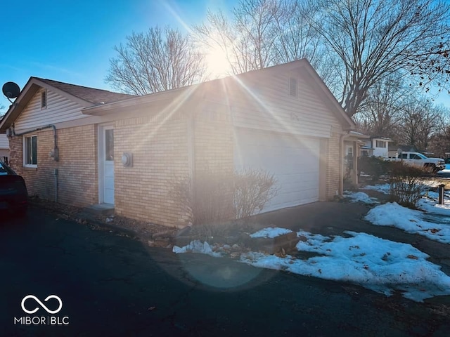 snow covered property featuring a garage