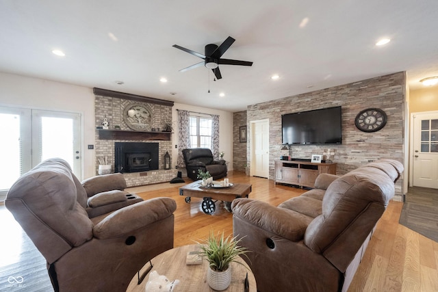 living room with ceiling fan and light hardwood / wood-style flooring