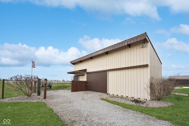 view of property exterior featuring a yard and an outdoor structure