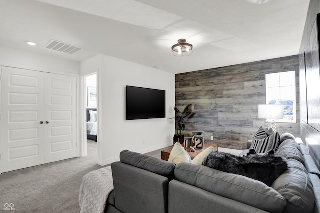 living room featuring carpet floors and wooden walls