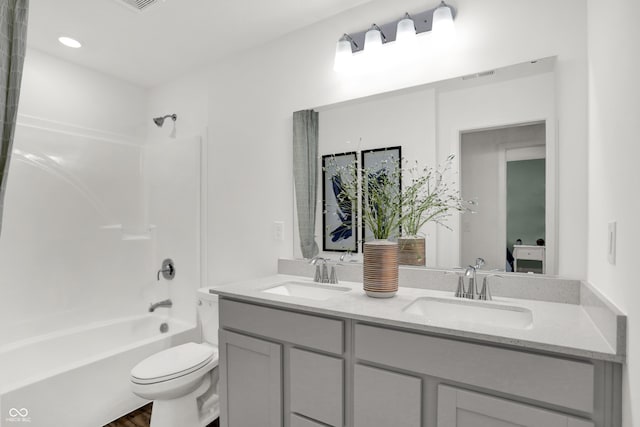 full bathroom featuring vanity,  shower combination, and toilet