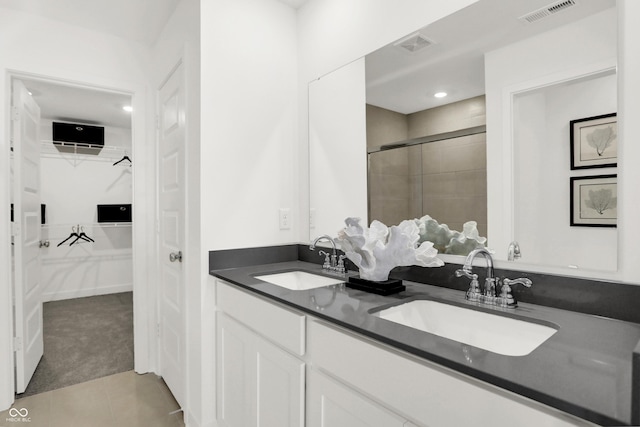 bathroom with tile patterned floors, an enclosed shower, and vanity