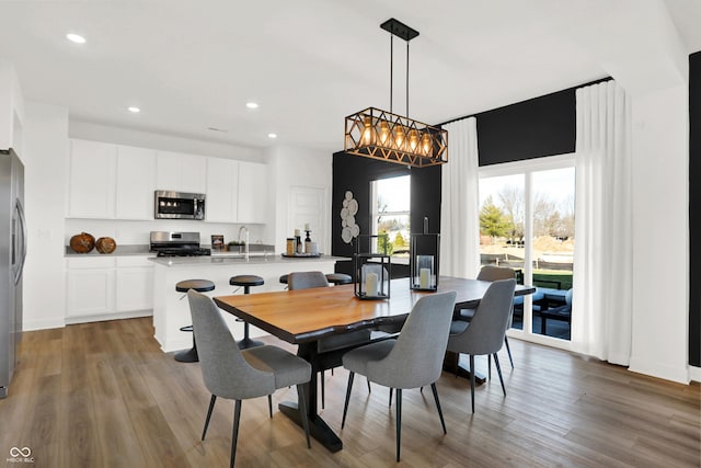 dining area with hardwood / wood-style flooring and sink