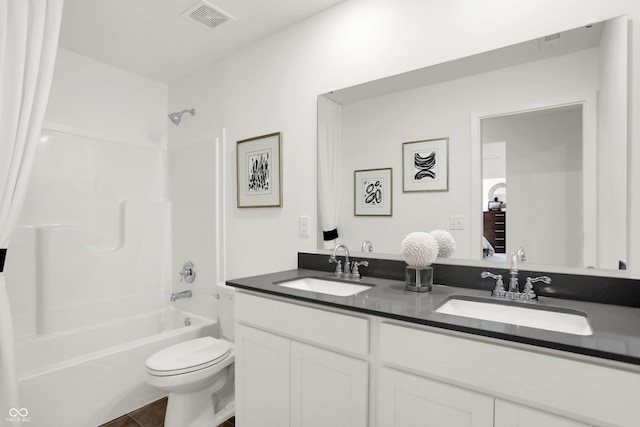 full bathroom featuring tile patterned flooring, vanity,  shower combination, and toilet