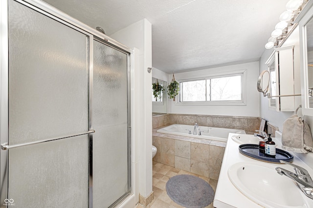 full bathroom with tile patterned floors, toilet, a textured ceiling, vanity, and independent shower and bath