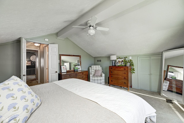 bedroom featuring vaulted ceiling with beams, a textured ceiling, carpet floors, a closet, and ceiling fan