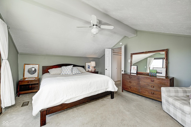 carpeted bedroom with lofted ceiling with beams, a textured ceiling, and ceiling fan