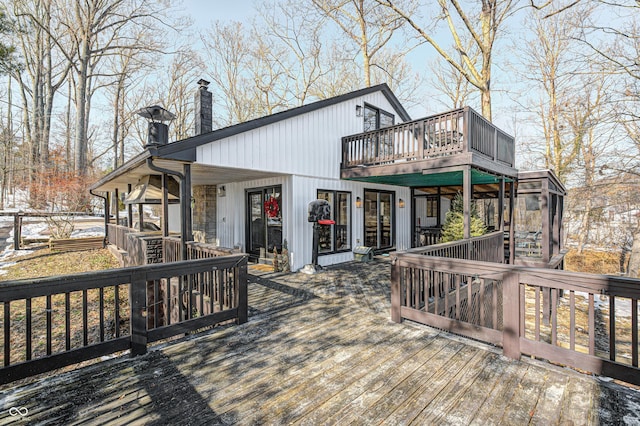 wooden deck with a sunroom