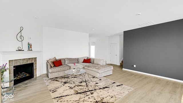 living room featuring a fireplace and light hardwood / wood-style floors