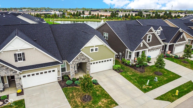 craftsman-style house featuring a water view and a garage