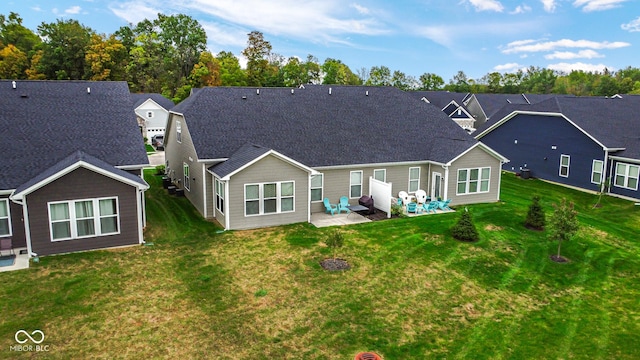 rear view of house featuring a patio area and a lawn