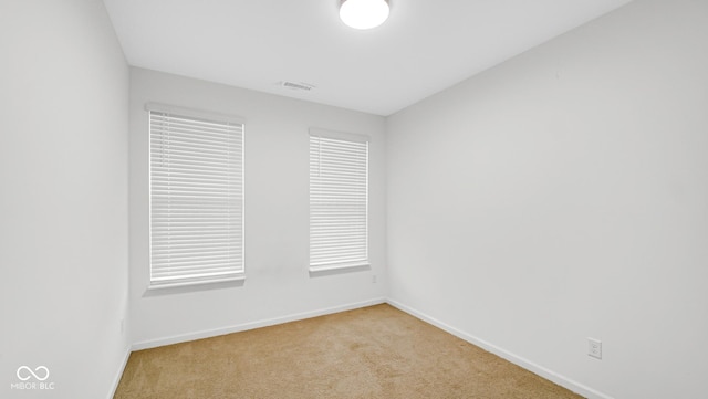 empty room featuring light carpet