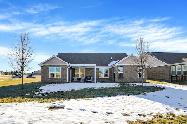 snow covered property with a yard