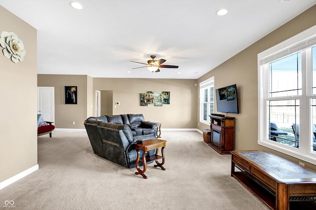 living room featuring ceiling fan and light colored carpet