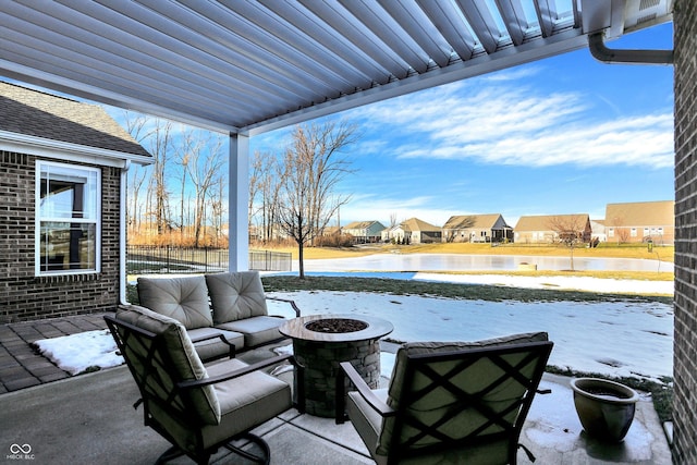 view of patio / terrace featuring a water view and a fire pit