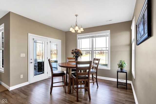 dining area featuring a chandelier and dark hardwood / wood-style flooring